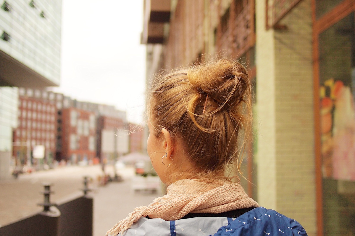 Solo female traveler confidently navigating busy international market with safety awareness and preparation