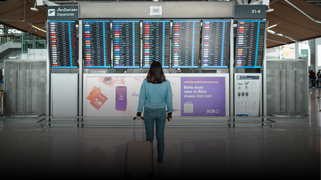 Confident solo female traveler with backpack at airport departure gate preparing for safe international travel