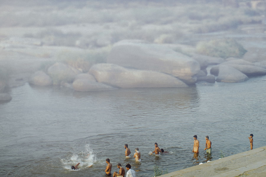 Group of explorers standing on a cliff looking at the horizon