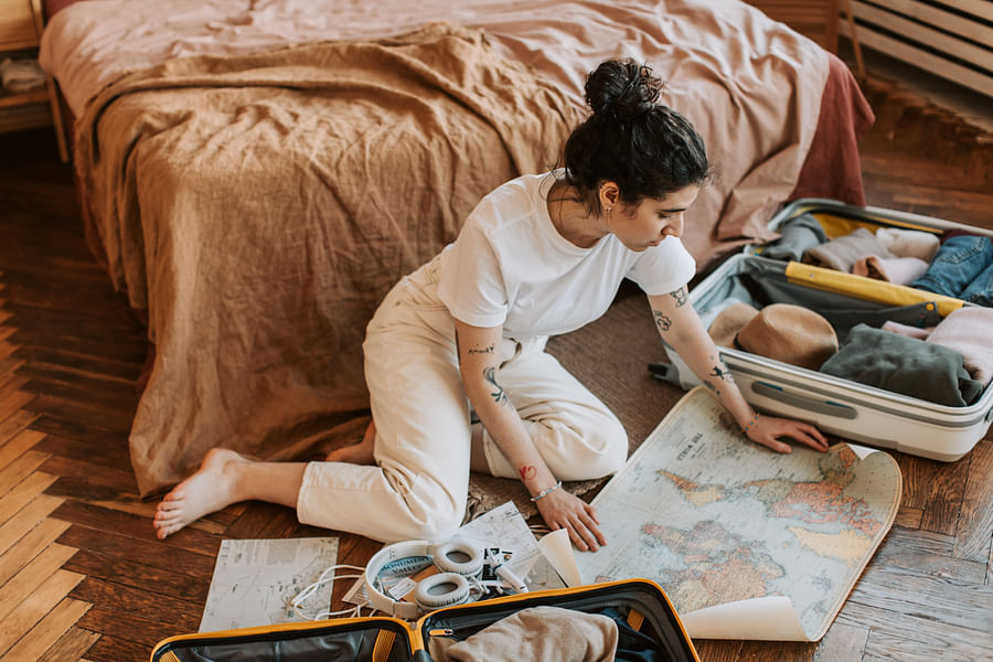 Traveler meticulously planning journey using a map